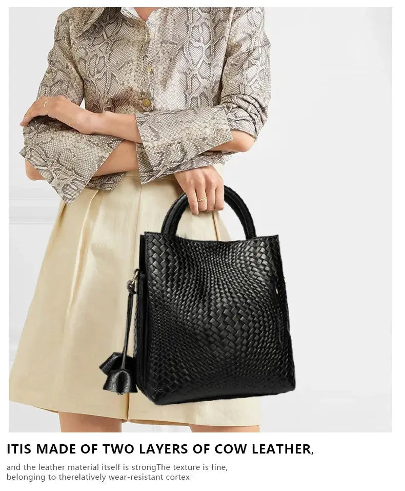 Woven black cowhide handbag with top handles, versatile for daily commuting