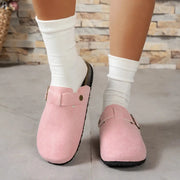 Women's pink suede slip-on flats with decorative strap and black sole
