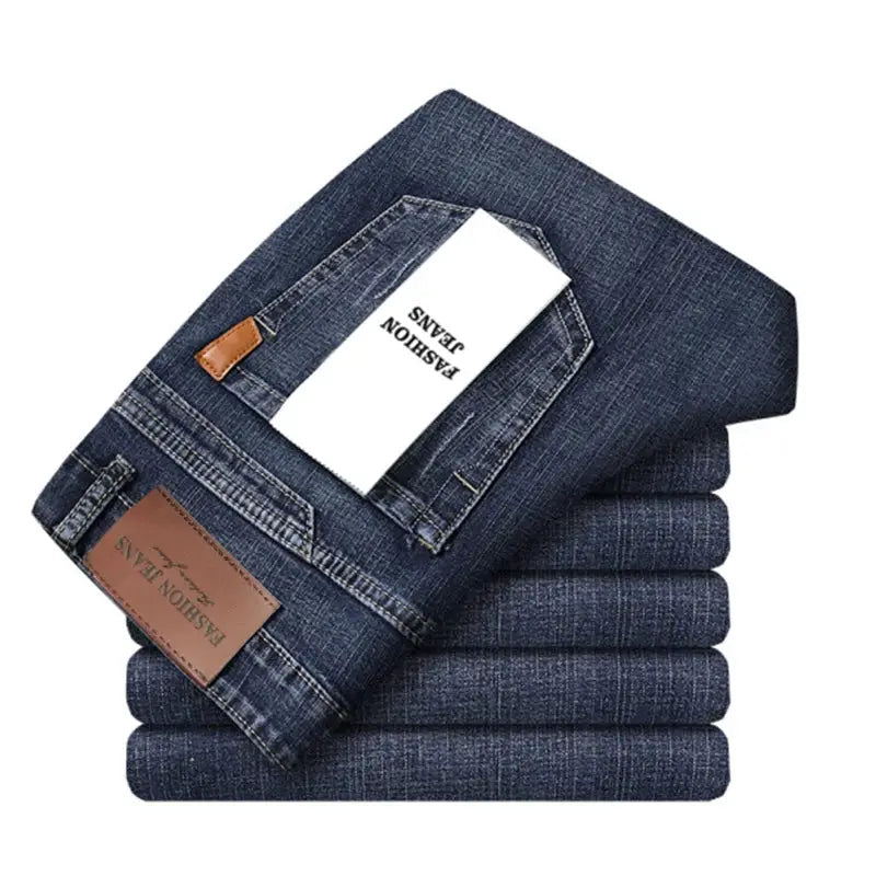 Men's blue denim jeans stacked with brown leather patch and white tag