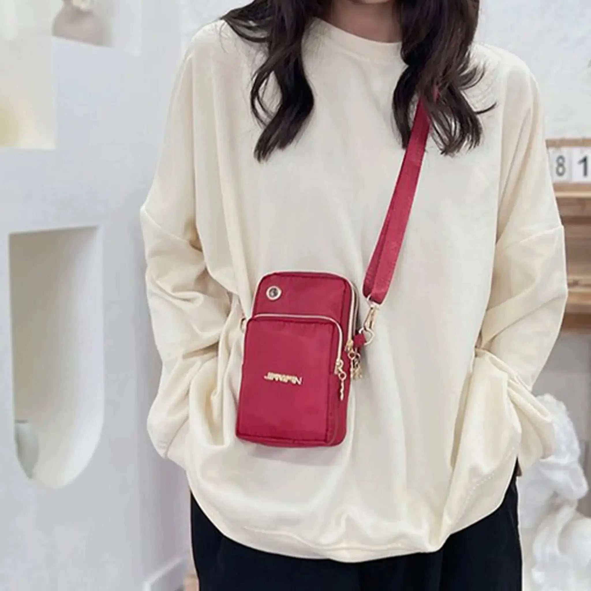 Mobile phone crossbody bag in red with neck strap by Simples Market