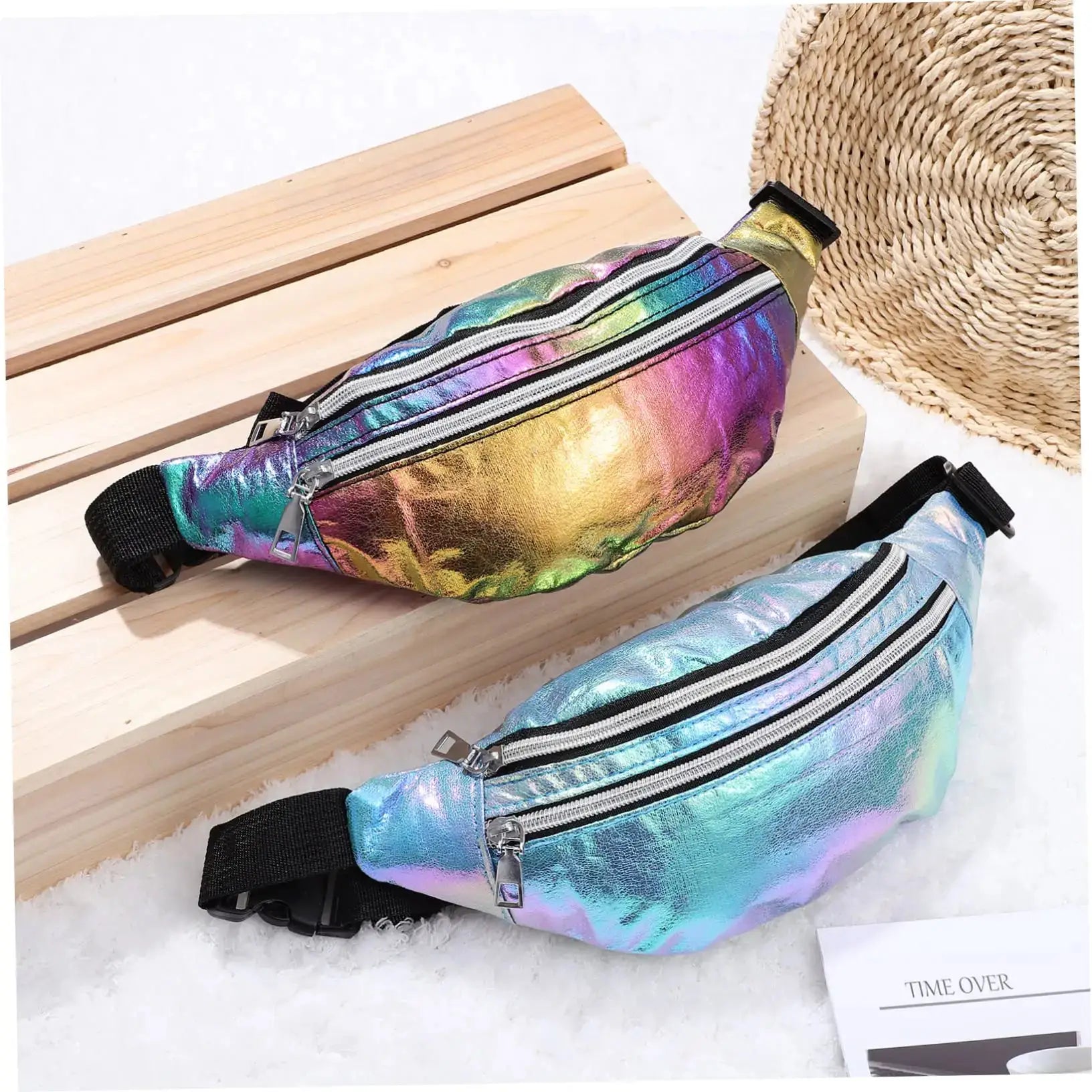 Three holographic fanny packs with rainbow metallic finish, zip closures, and adjustable black straps.