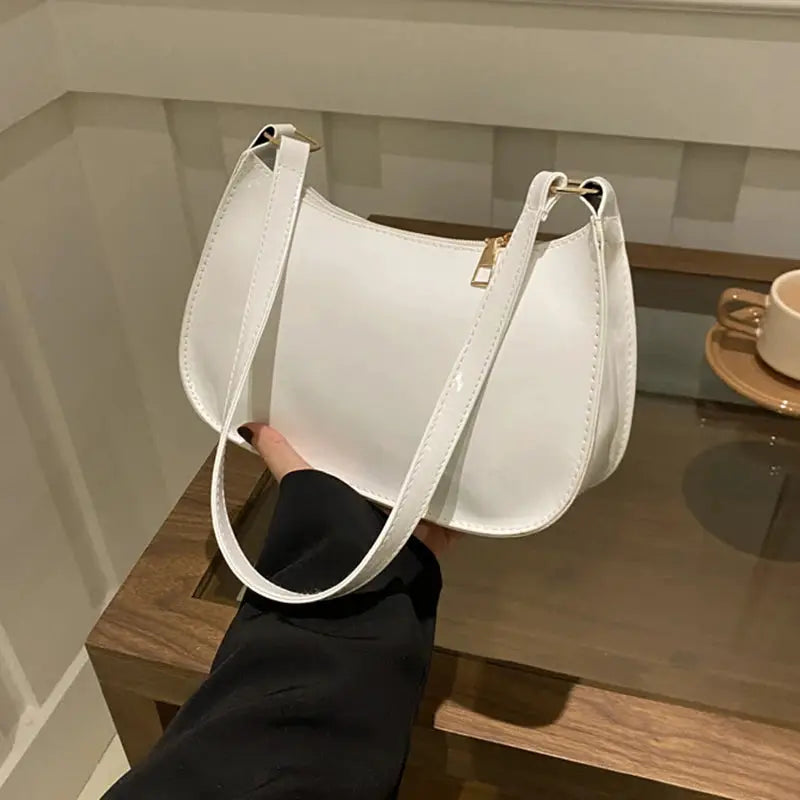 White PU leather shoulder bag with long strap, retro hobo-style design.