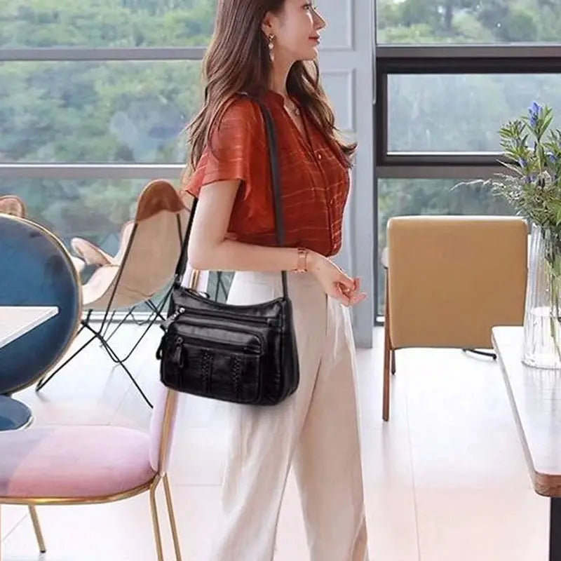 Women's PU multilayered soft leather crossbody bag in black with multiple zipper pockets