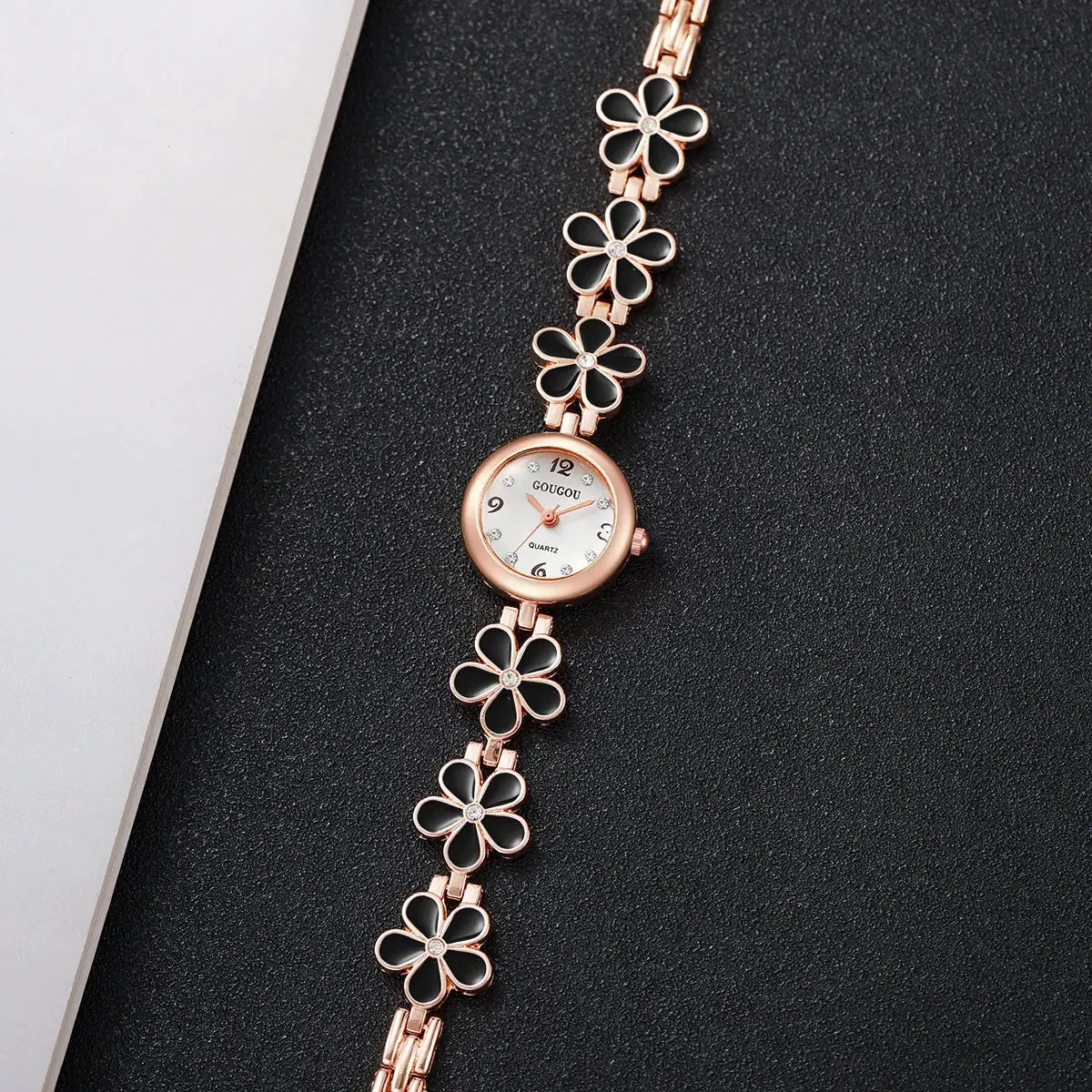 Fashion flower bracelet watch by Simples Market; rose-gold tone with black enamel clover petals and crystal accents