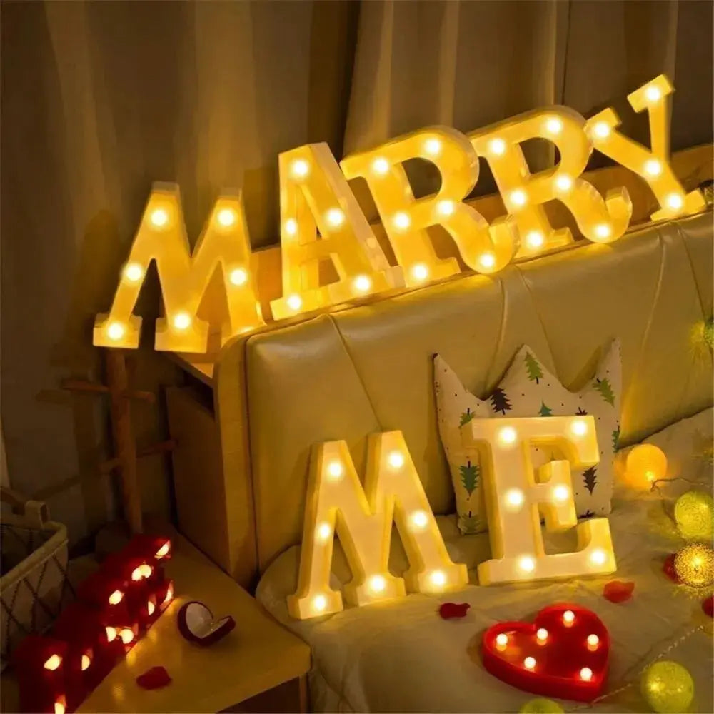 Set of 7 luminous alphabet letter lamps spelling MARRY ME with warm white LEDs