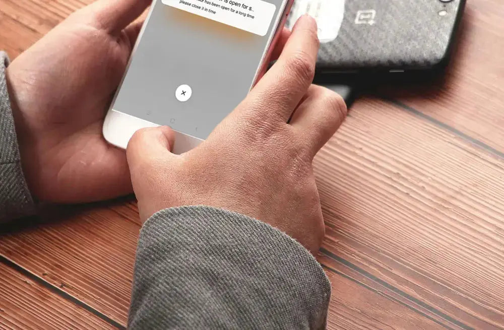 Smart garage door opener controller on smartphone; white Tuya-compatible device works with Alexa and Google Assistant