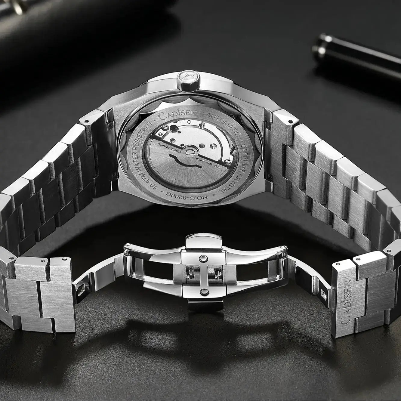 CADISEN diver watch with stainless steel bracelet and transparent sapphire caseback showing Miyota 8215 movement