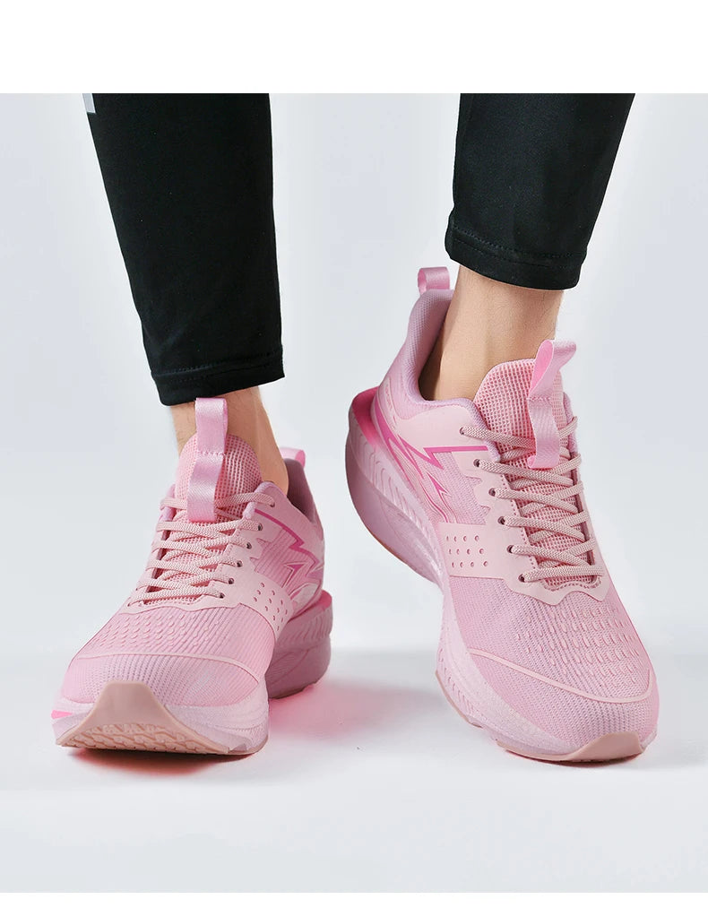 Pair of women's pink mesh running shoes with laces and pull tabs