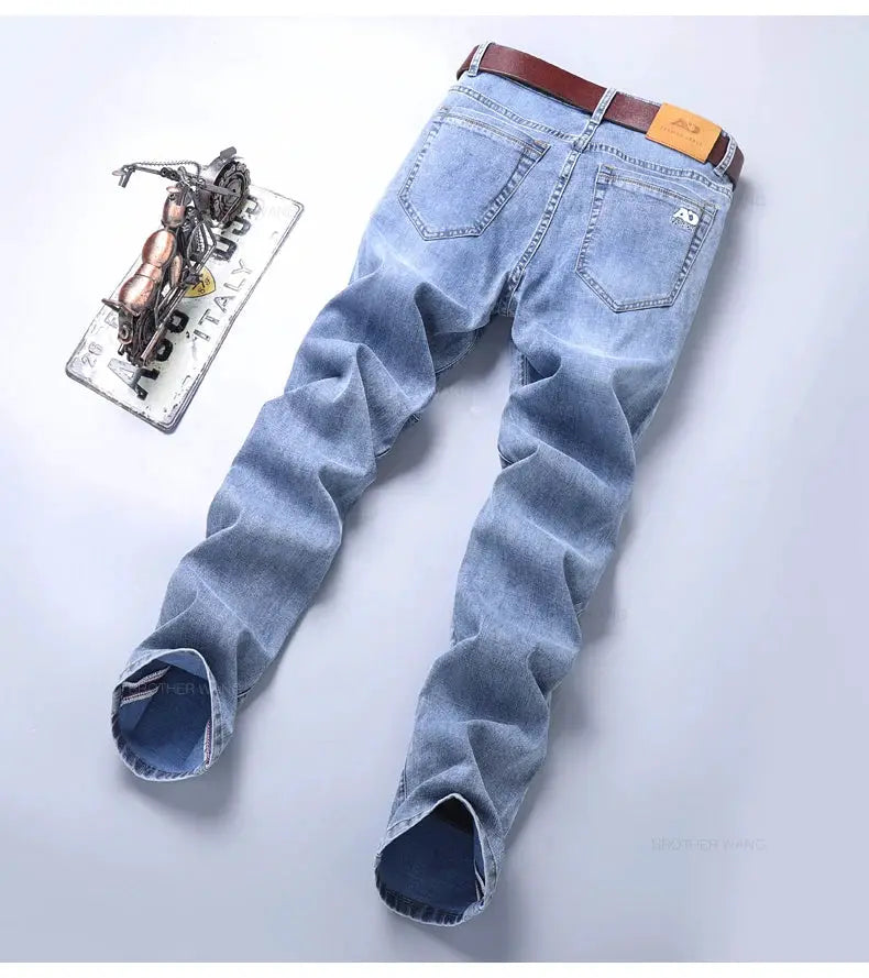 Spring men's light-blue slim denim jeans with stretch fabric and brown belt