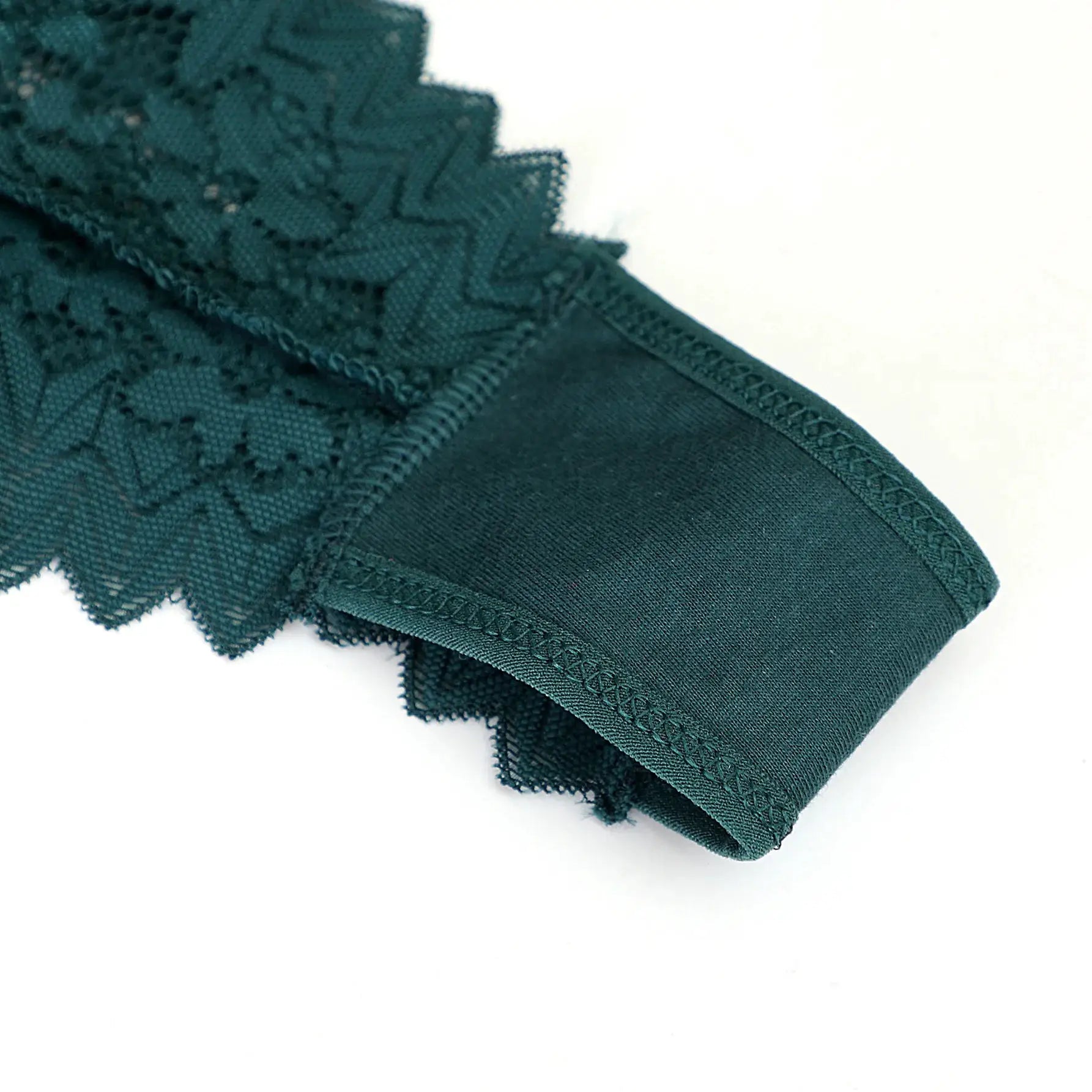 Women's teal lace thong underwear with low waist and scalloped lace trim.