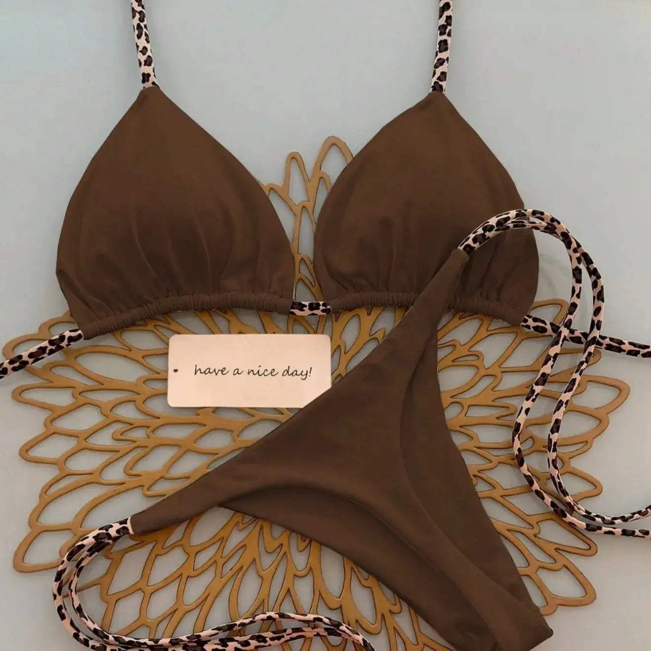 Simples Market brown leopard-print two-piece bikini set with triangle top and thong bottom, leopard straps
