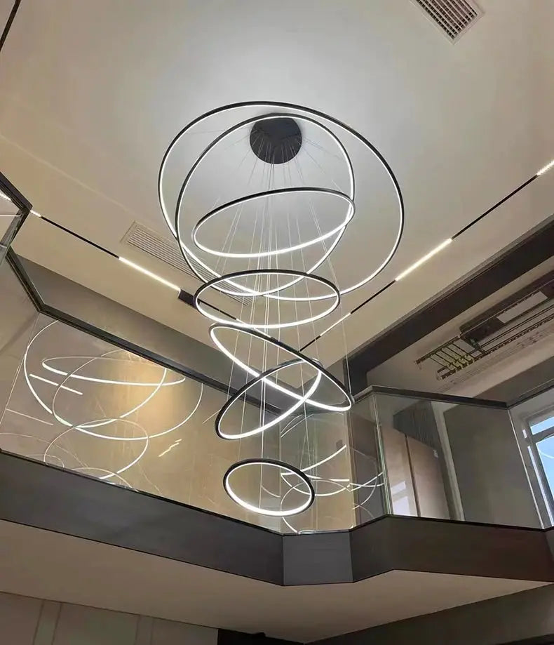 Modern LED pendant light with concentric circular rings, black metal finish, hanging chandelier for living room