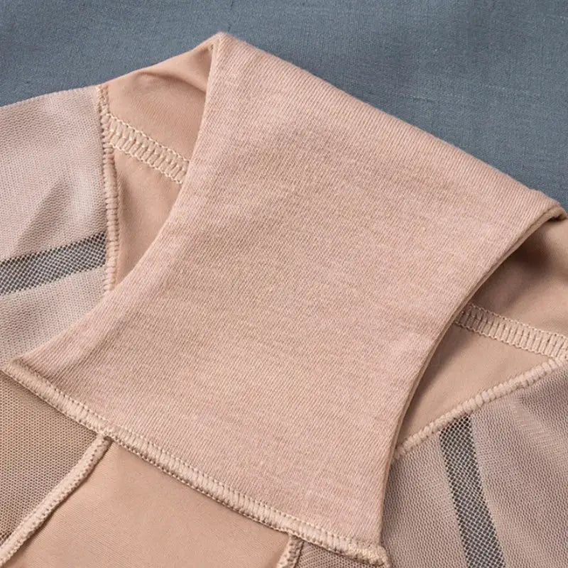 Two-piece beige ice-silk tummy-control panties with mesh panels and mid-waist shaping.