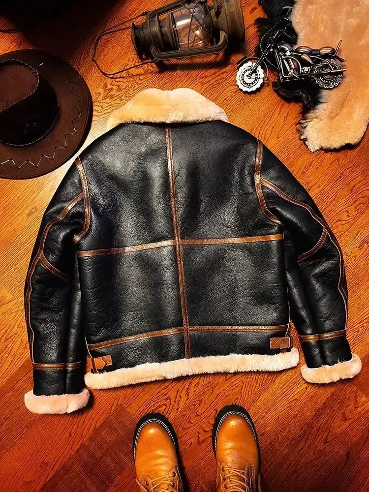 B3 shearling leather bomber jacket in black with tan fur trim and brown piping.
