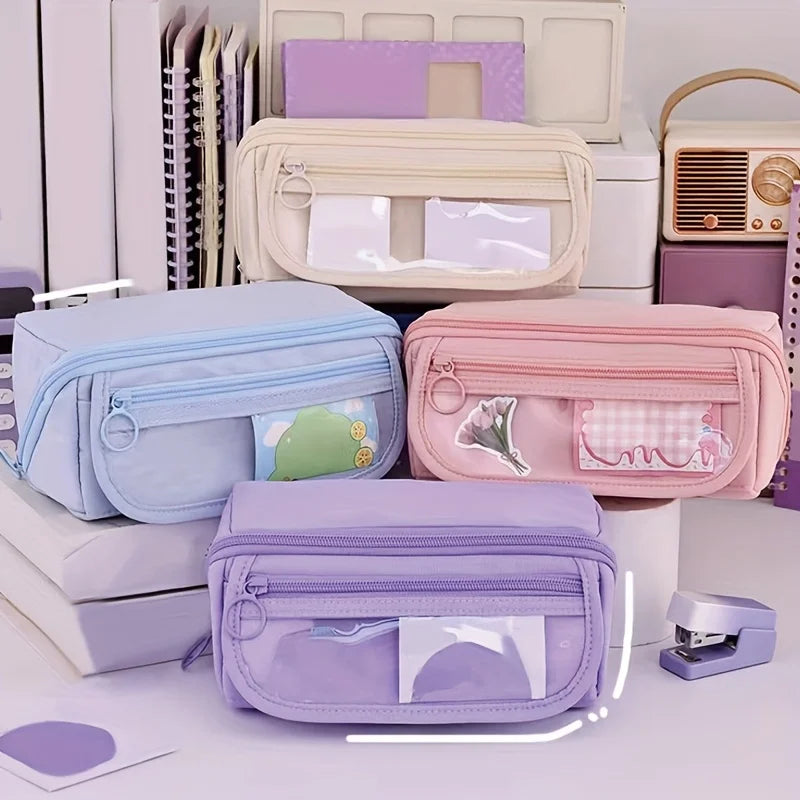 Four pastel pencil cases by Simples Market with clear front pockets in blue, pink, lavender, and purple