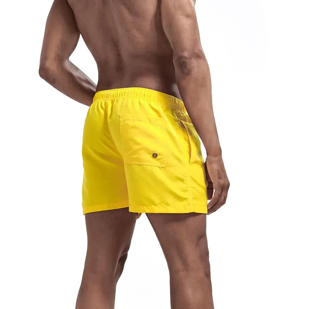 Men's yellow quick-dry swim shorts by Simples Market with back pocket
