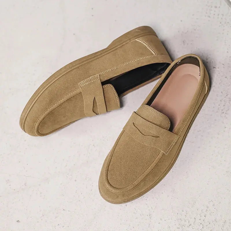 Pair of tan suede slip-on men's loafers with a soft sole for casual daily outdoor wear, lightweight comfort.