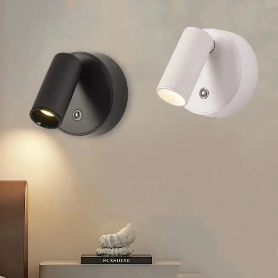 Rechargeable LED wall lamp pair with swiveling cylindrical spotlights; black and white versions shown.