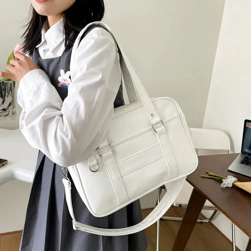 White PU leather Japanese style JK bag with top handle and detachable shoulder strap, simple school crossbody bag
