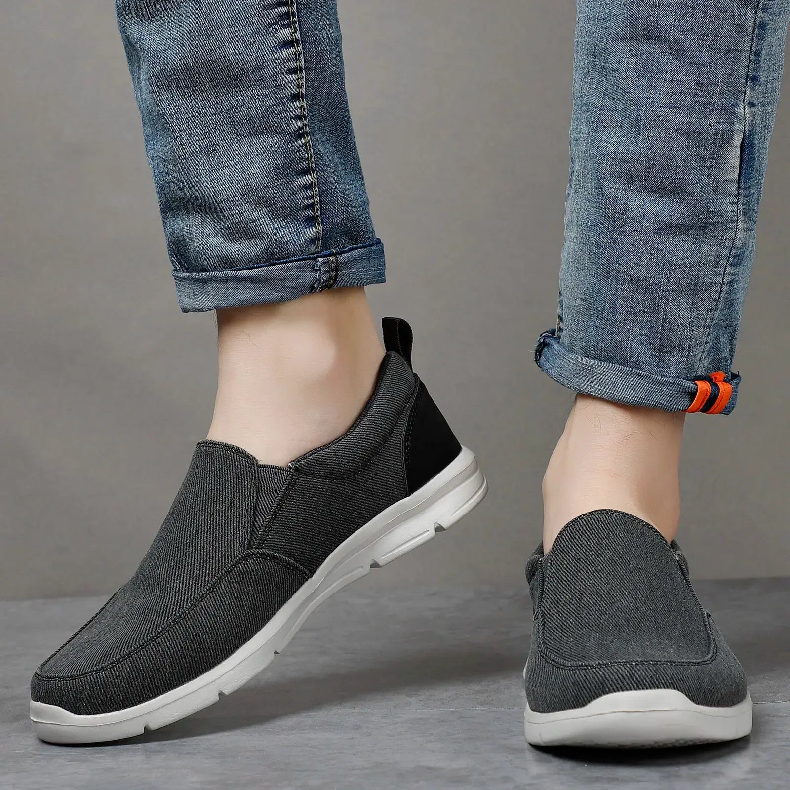 Men's gray canvas slip-on sneakers with white sole for casual outdoor walking