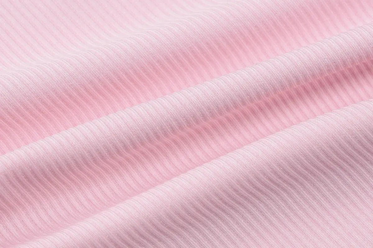 Hugcitar pink ribbed fabric close-up with soft parallel knit lines