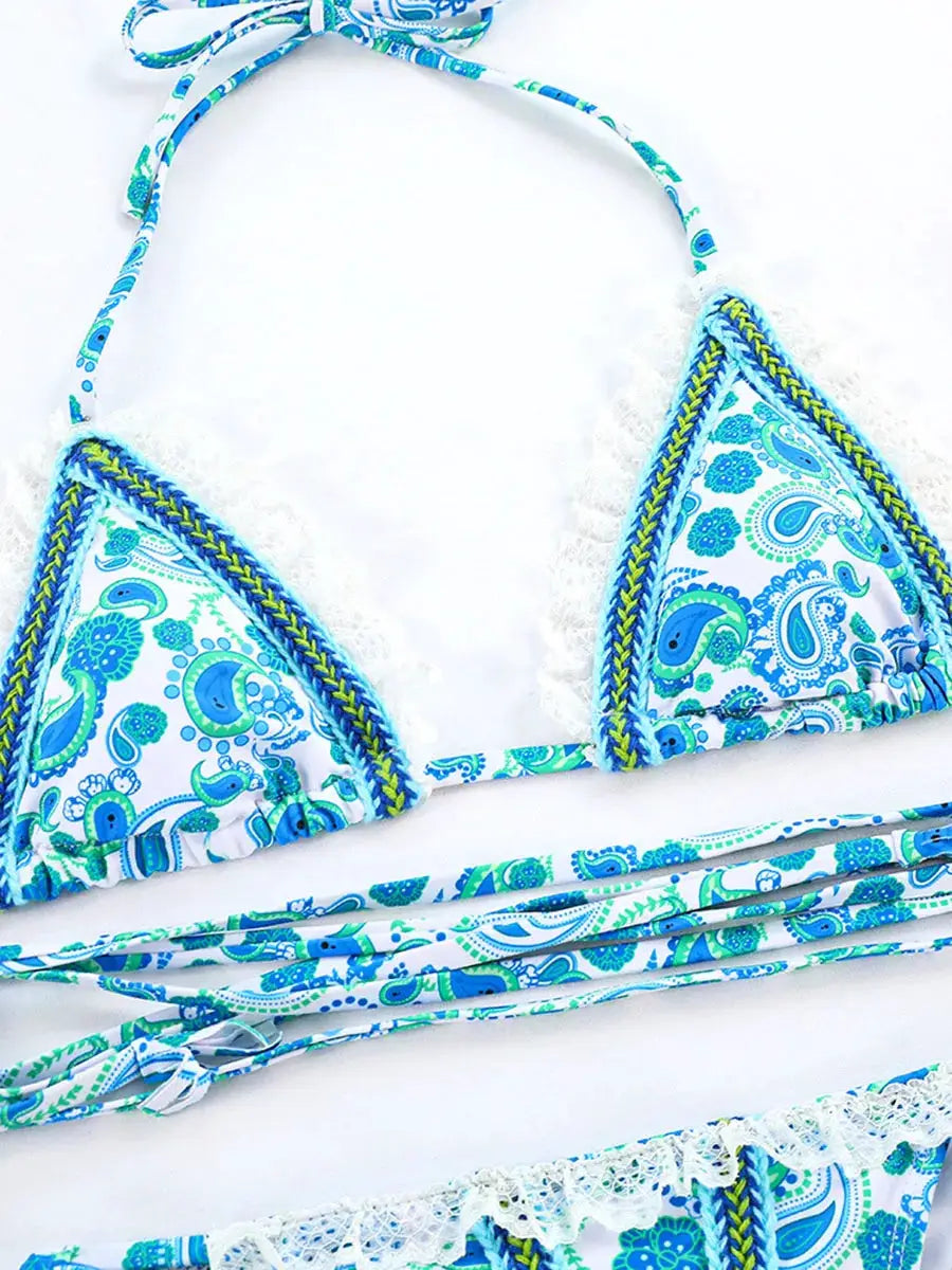 Two-piece bikini set in blue paisley print with white lace trim and tie straps.