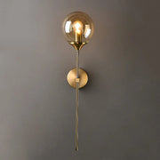 Modern glass globe wall lamp sconce in gold brass finish by Simples Market for living room or hallway.