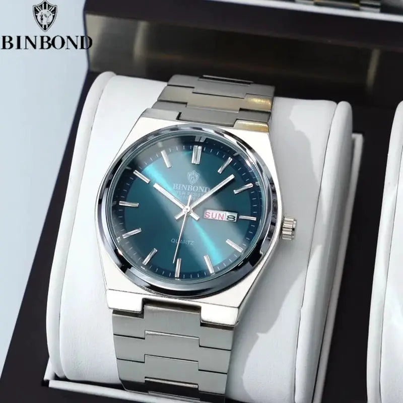 BINBOND men's stainless steel watch with blue dial, date window, and metal bracelet in a display box
