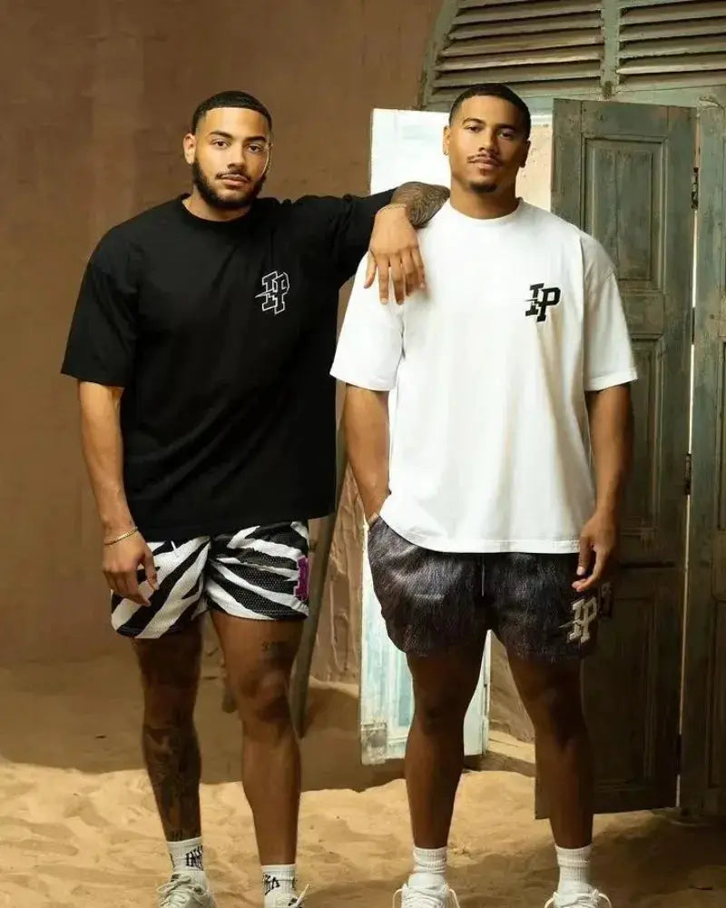 Mens quick-dry mesh shorts by Simples Market; two men model black/white zebra-print and dark gray shorts.