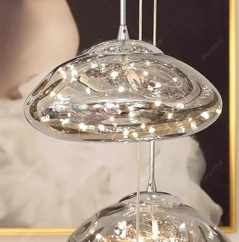 Pendant light by Simples Market with clear glass shade and twinkling LED string lights