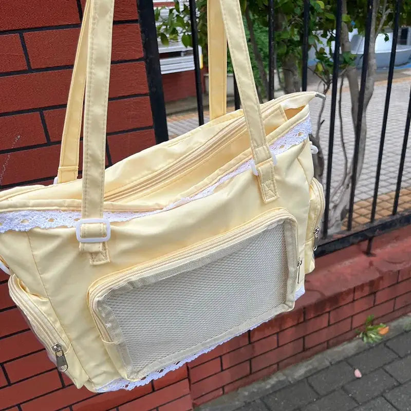 Ballet Girl Large Appetite itabag by Simples Market pale yellow crossbody with lace trim and front mesh pocket.
