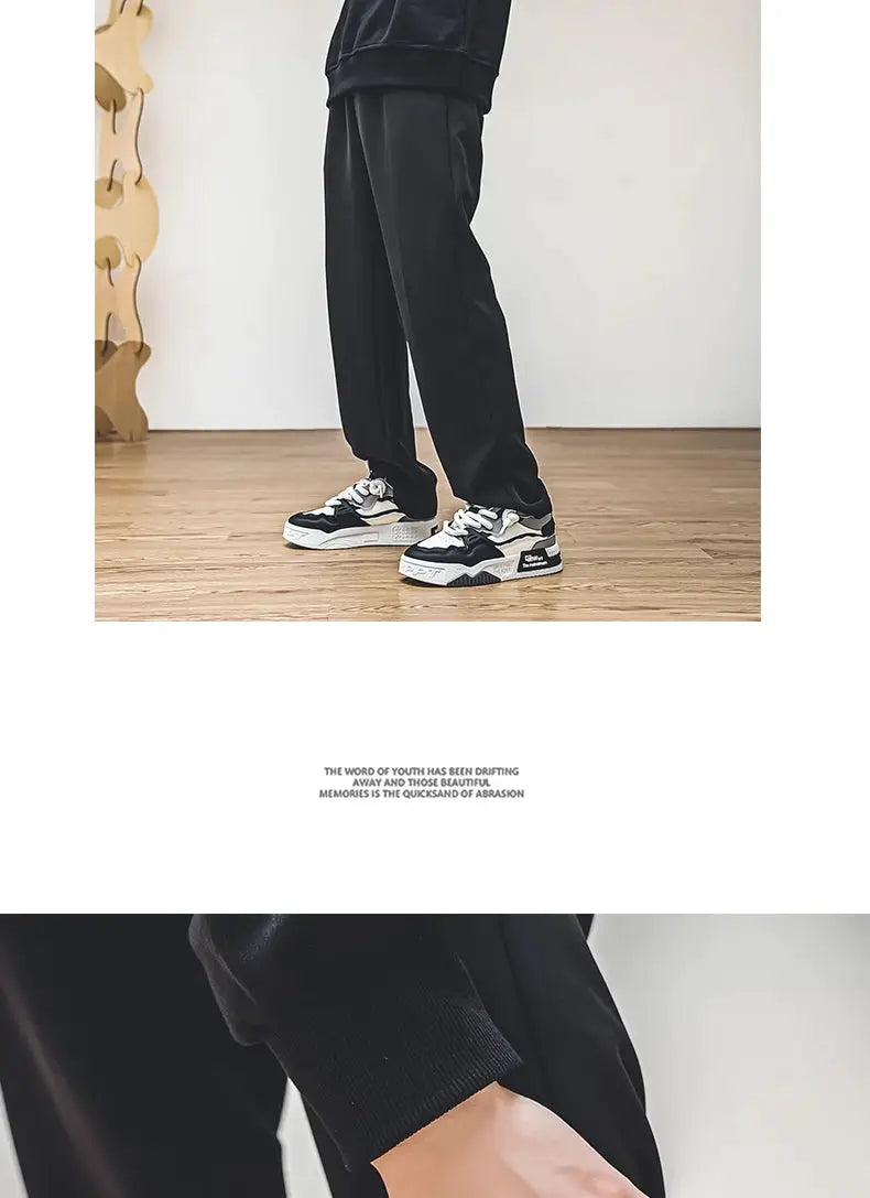 Pair of men's trendy skate shoes in black and white, lace-up casual sneakers with non-slip soles.
