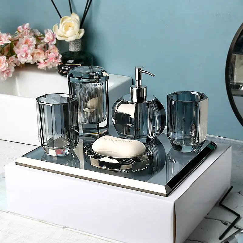 Clear glass bathroom set on mirrored tray; 6-piece with lotion bottle, dispenser, toothbrush holder, cup and soap dish