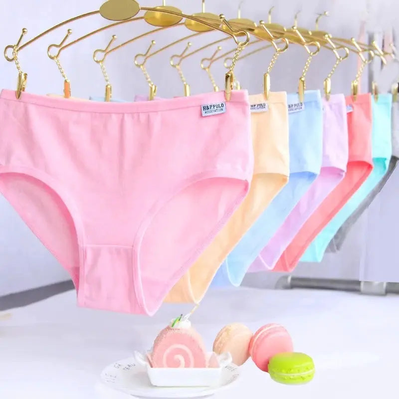 7-pack women's cotton panties in pastel colors displayed on a hanger