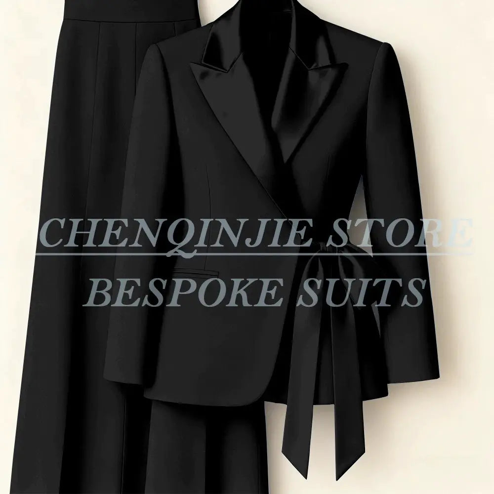 Black women's 2-piece suit set featuring a tailored blazer with peak lapel and waist tie, plus matching pants.