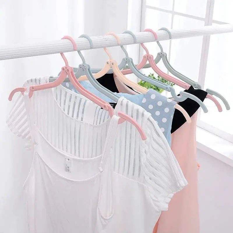 Foldable portable clothes hangers set by Simples Market, 5/10-pack, pastel pink, blue and gray on a rod