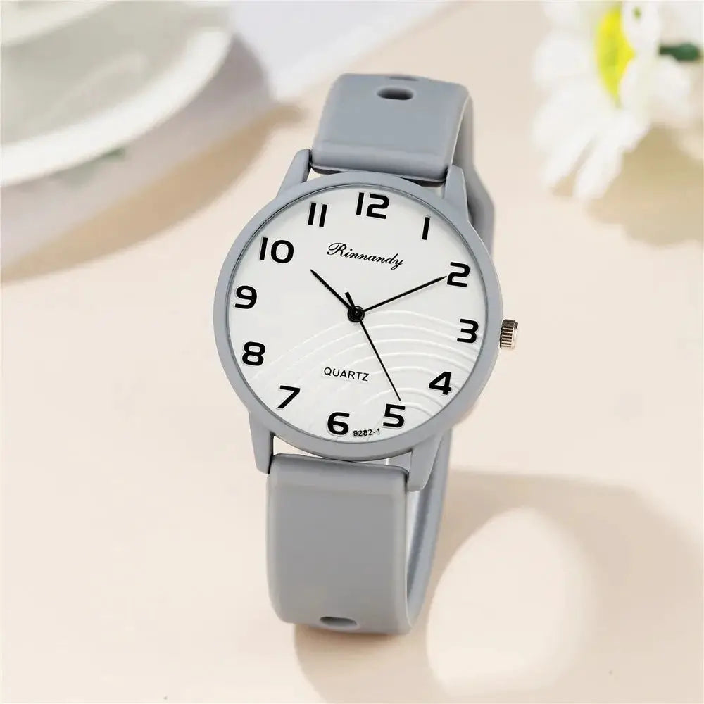 Women’s quartz watch with gray silicone strap and white Arabic-dial face by Rinnandy
