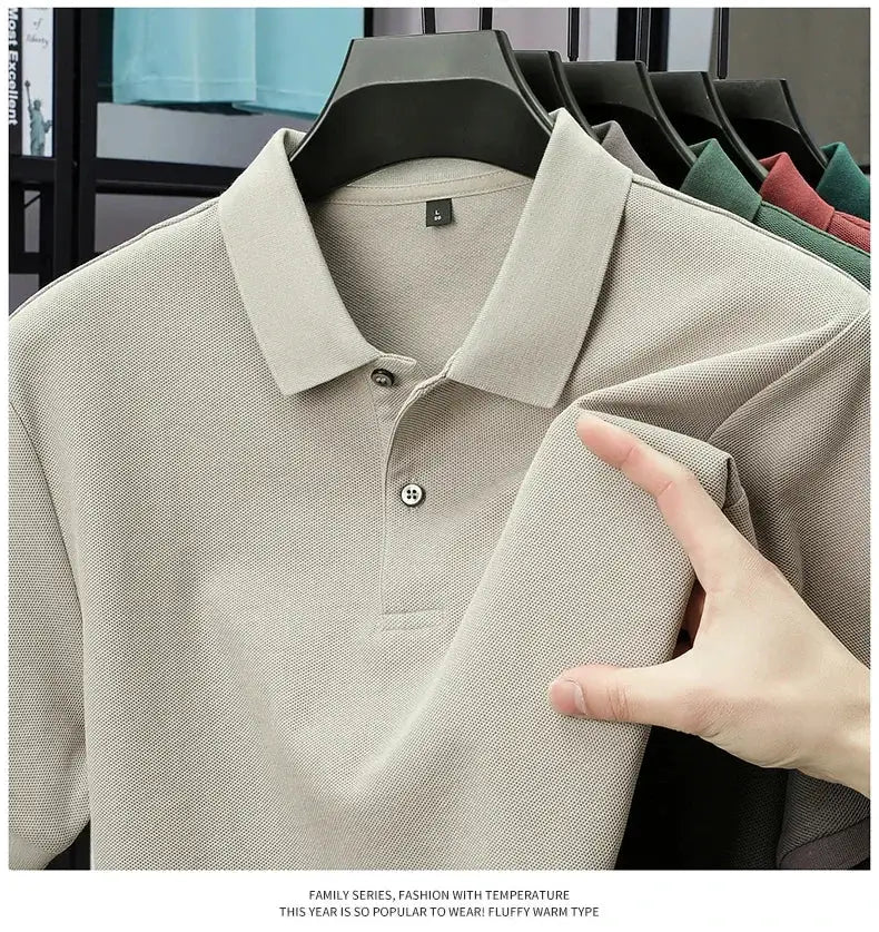 Men's 100% cotton polo shirt in beige with button placket on hanger; other colors visible in background