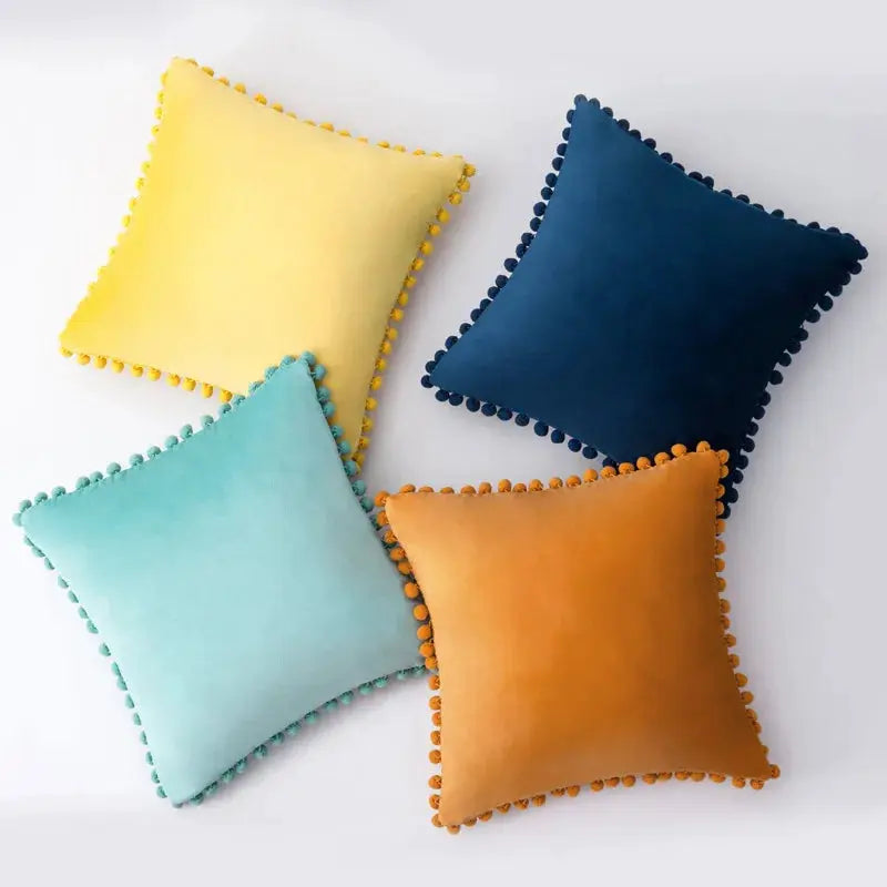 Velvet cushion covers by Simples Market; set of 4 colorful tassel-fringed covers for Boho sofa.