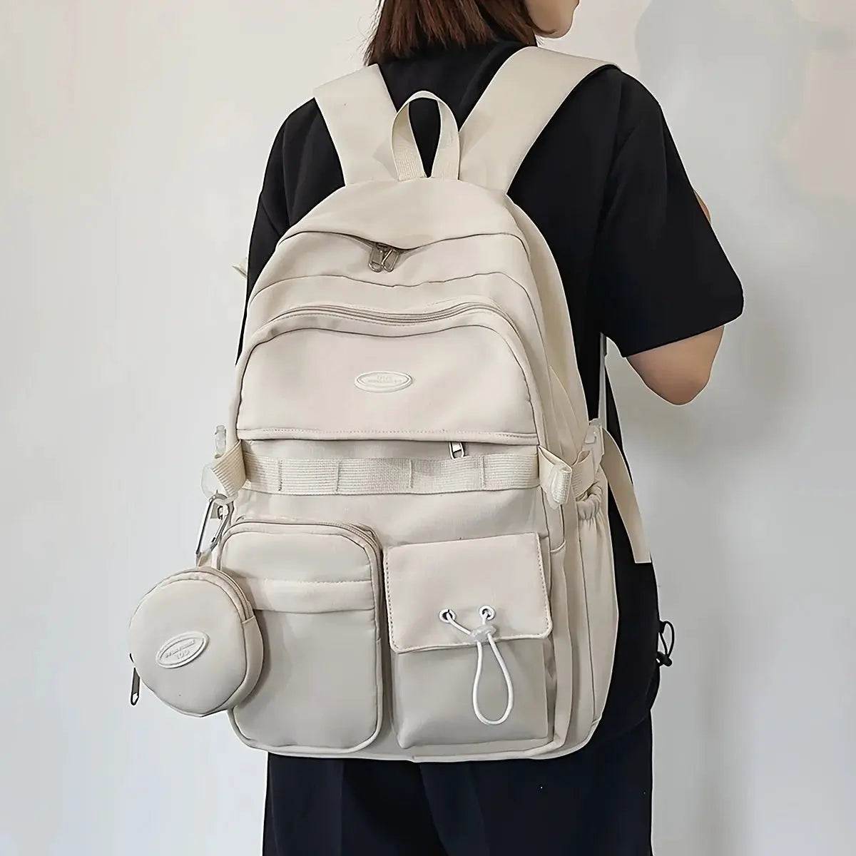 Backpack by Simples Market, beige large-capacity school/travel bag with multiple pockets and a round attached pouch