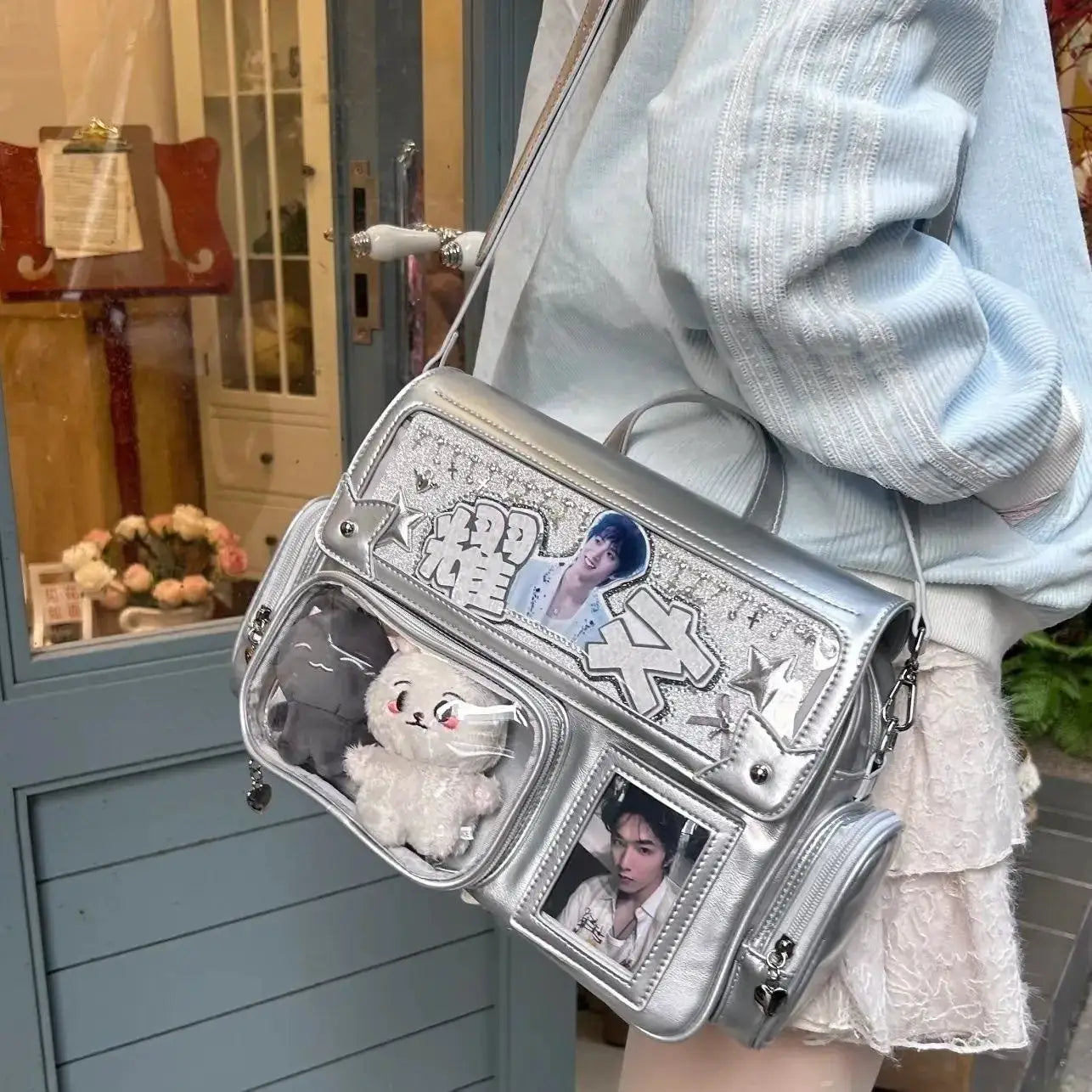 Silver square leather backpack with anime patches, large capacity, and a clear front pocket showing a plush bear