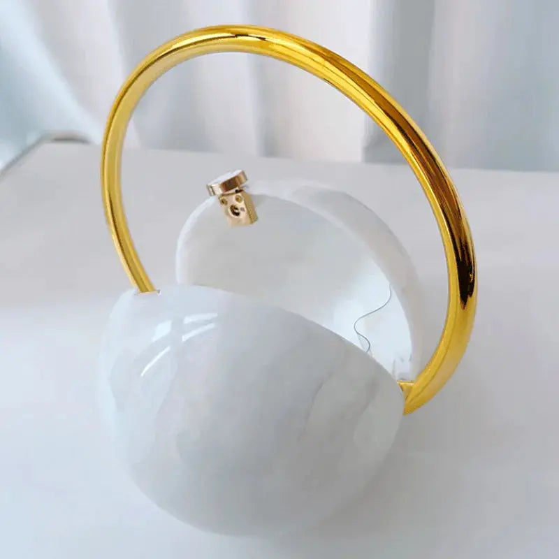 Luxury marble ball clutch with gold circular handle, acrylic evening bag
