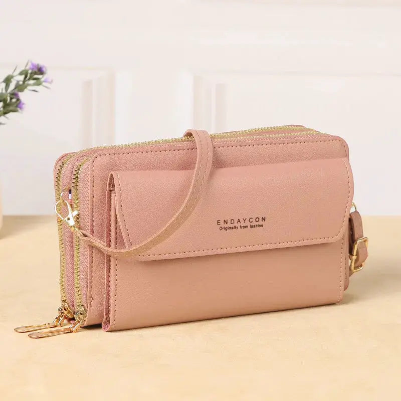 Women's pink crossbody bag with double zippers, front flap and gold hardware; ENDAYCON branding.