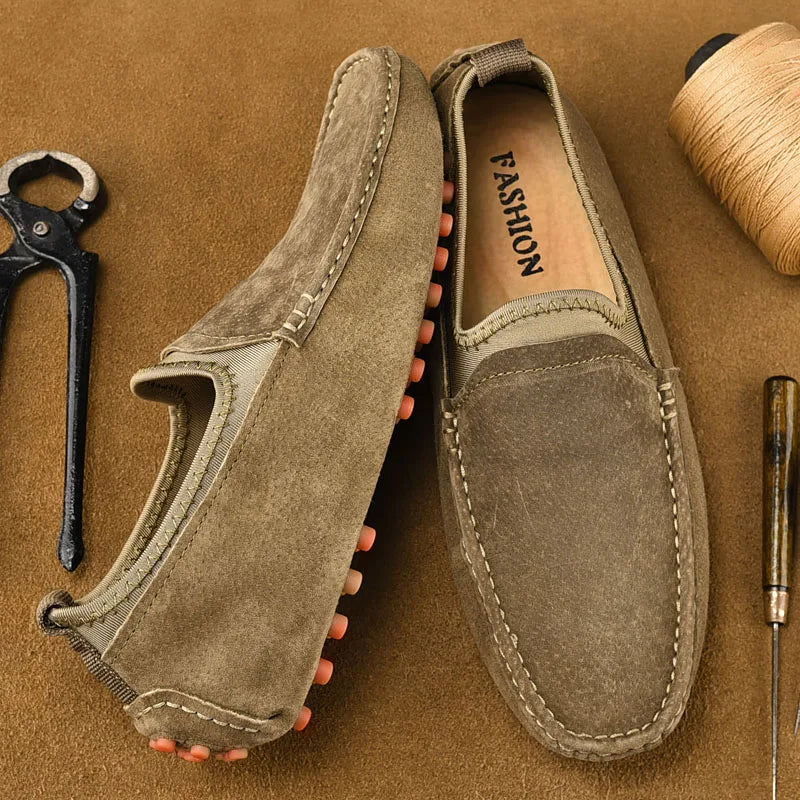 Pair of men's driving shoes in brown suede by Simples Market; handmade loafers with orange studded outsole