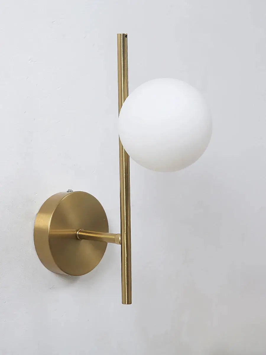 Modern LED wall lamp by Simples Market; brass finish with milky glass globe bedside wall light
