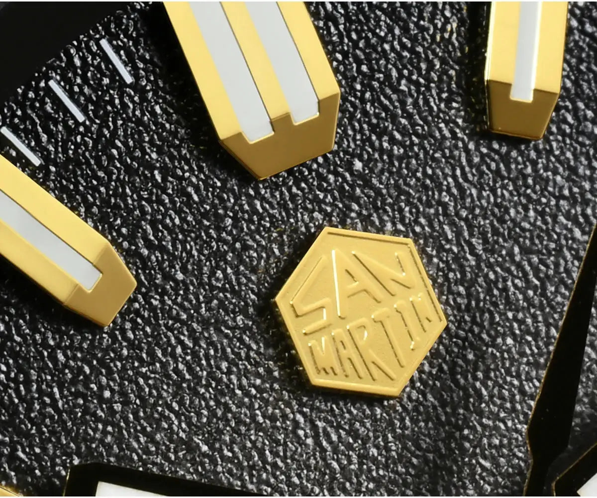 San Martin logo hex badge with gold-tone hardware components on a textured black background