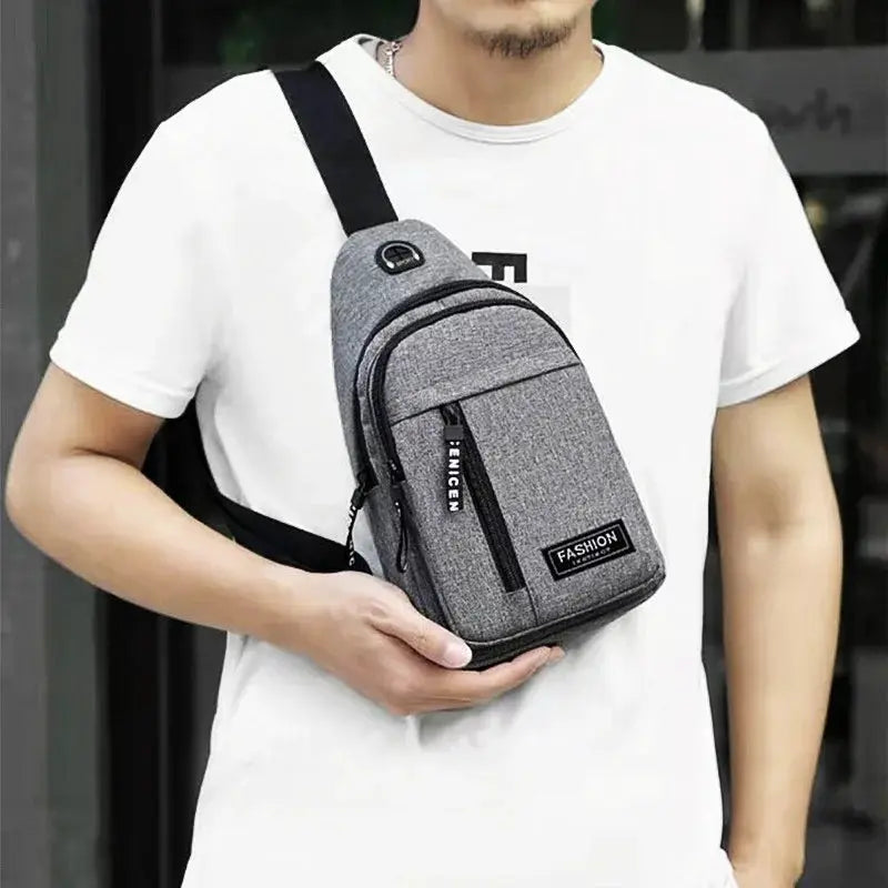 Multifunctional chest bag in gray Oxford cloth with black zippers, crossbody style.