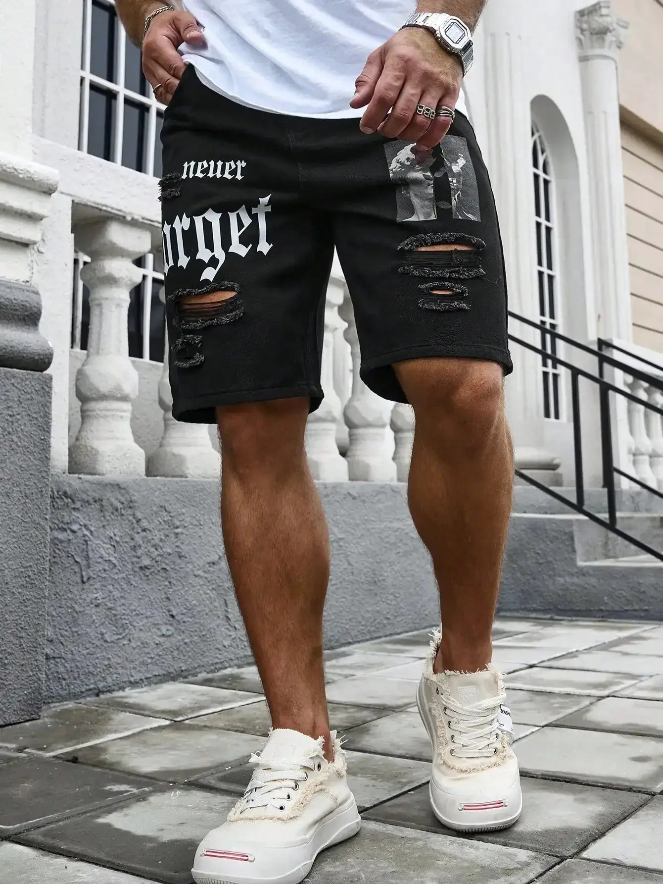 Men's black distressed denim shorts with ripped knees and patchwork, streetwear style
