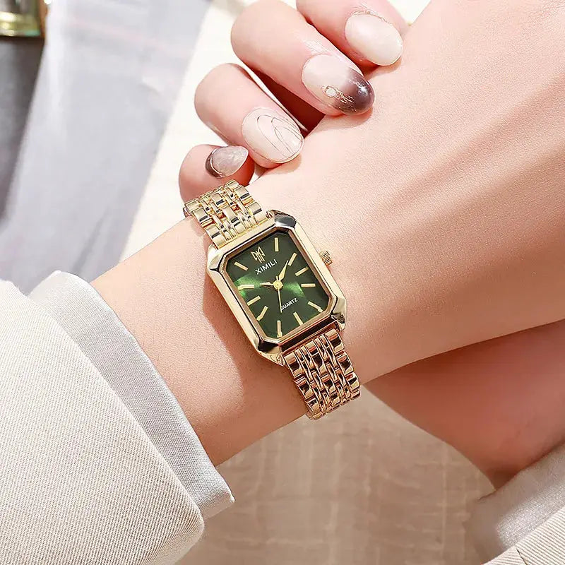 Luxury women's rectangular quartz watch with gold-tone steel band and green dial.