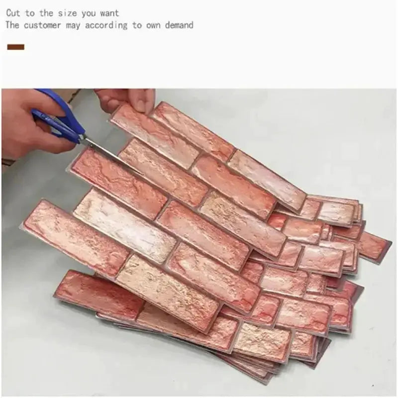 Self-adhesive 3D brick wall panels in peach-pink tones, stacked with a piece being cut by scissors.